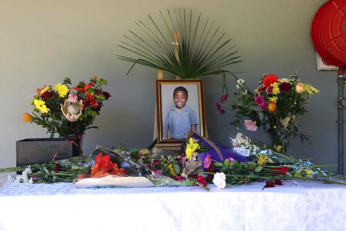 Flowers and a photo placed in memory of Olebogeng Mosime after his death. PHOTO: Supplied