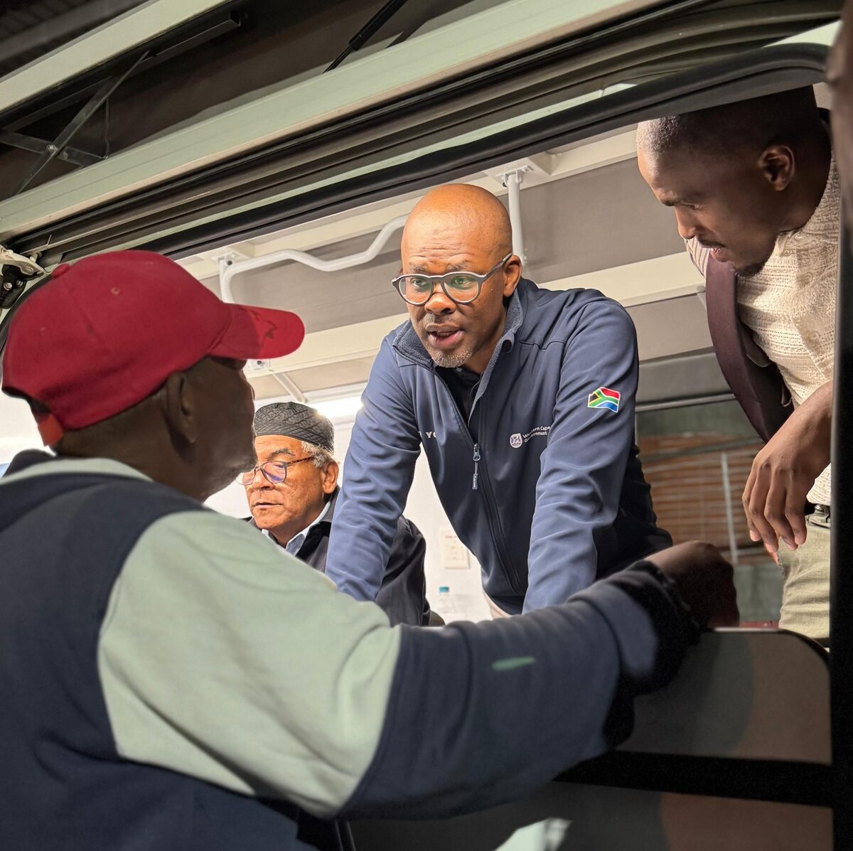 Minister Sileku engages with taxi drivers during the registration drive.