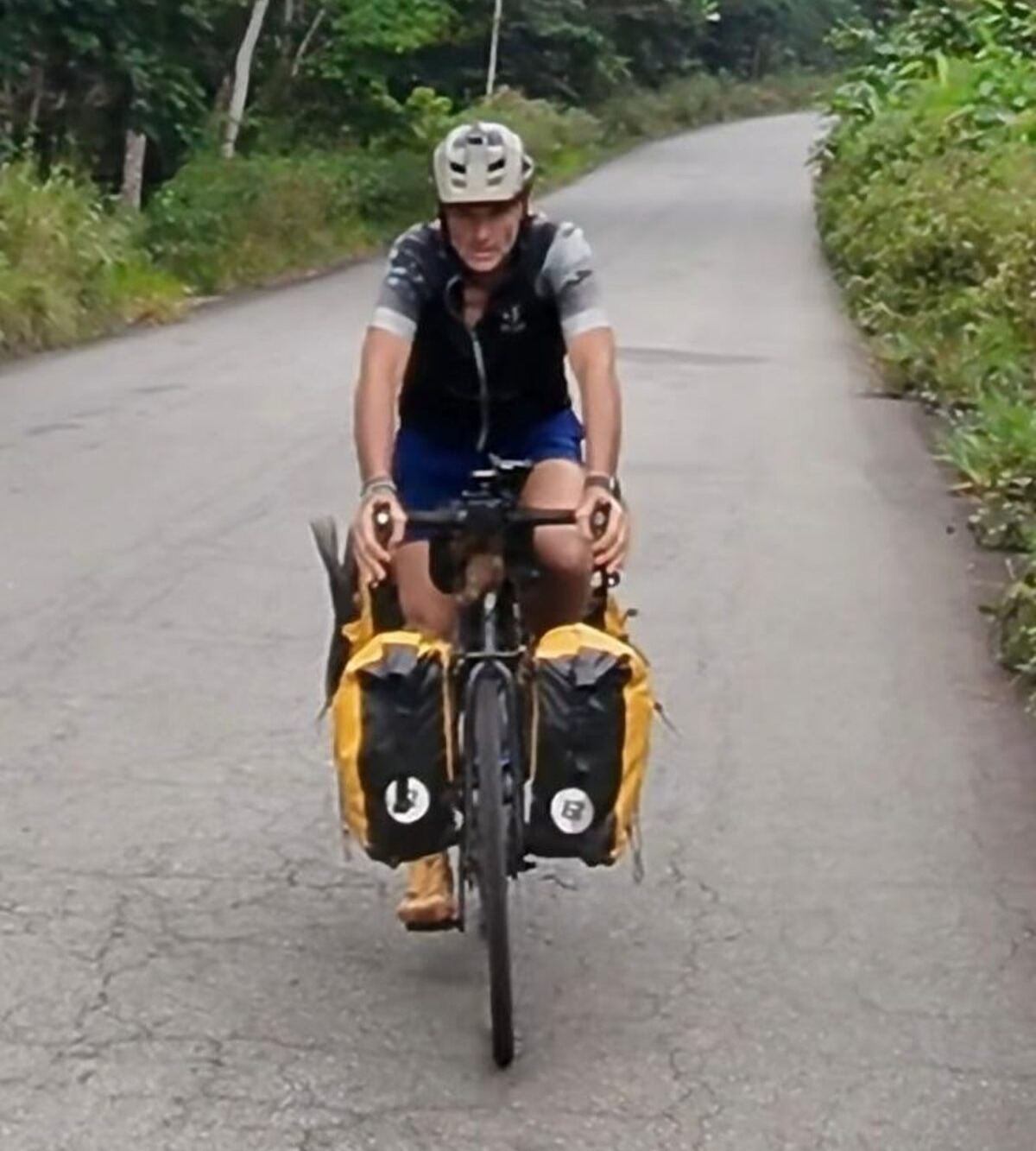 Maurice Edelson cycling on a road in Africa during his healing journey