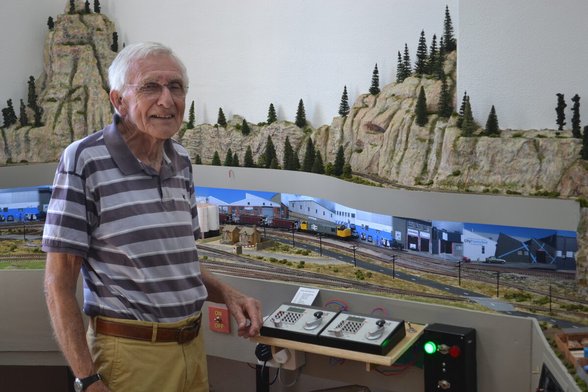 Michael Smout at the control panels of an intricate new model railway layout.