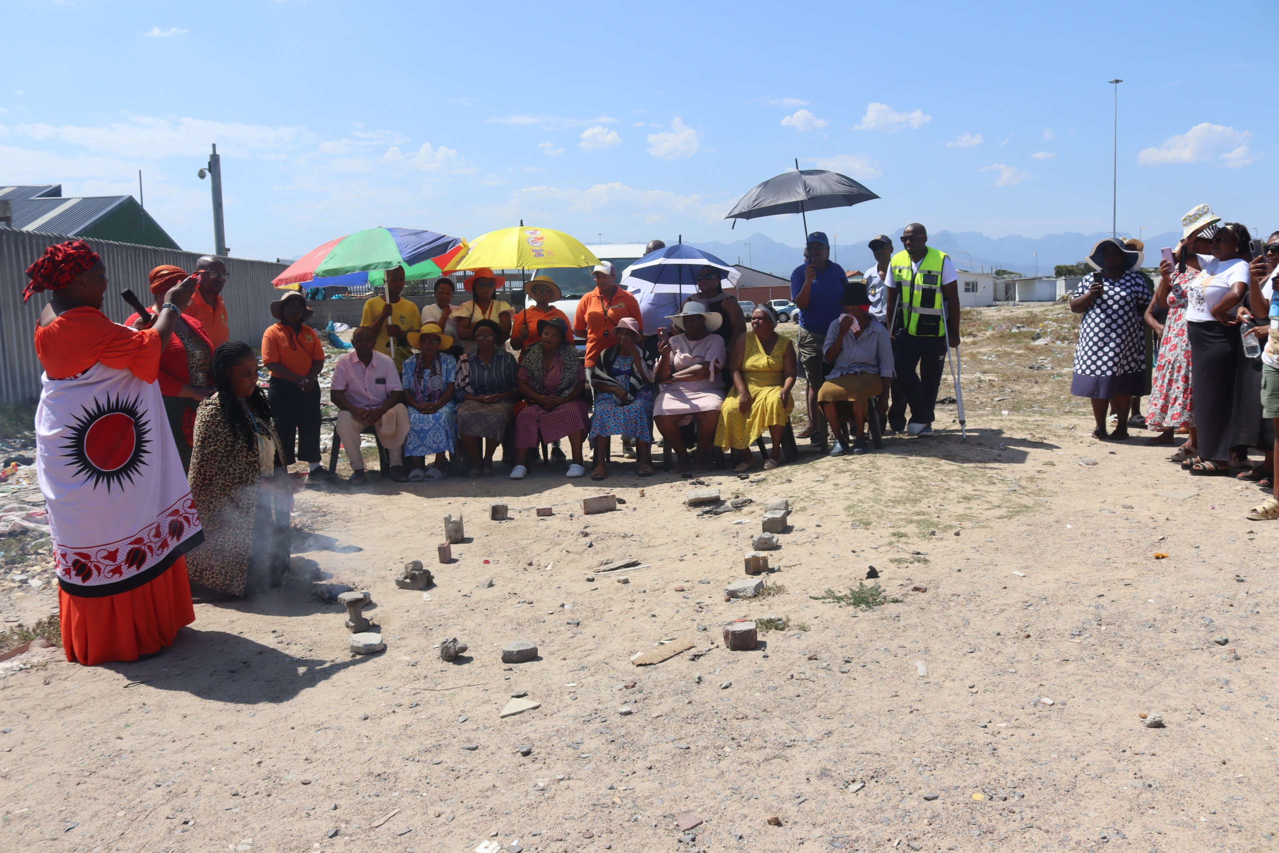 Lingelethu-West Spiritual Crime Prevention Forum member Wente Ntaka (in red) stands near the spot where Sisipho Mongo’s body was discovered while addressing the community.