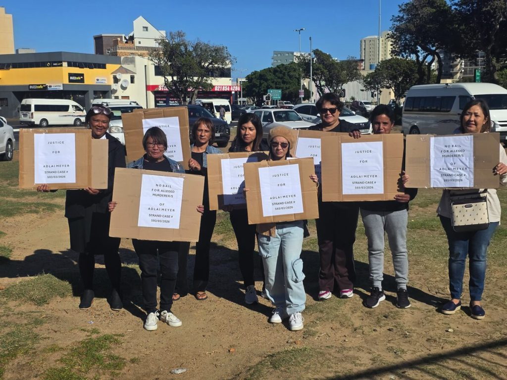 Family members of murder victim Adlai Meyer hold justice posters outside Strand Magistrates' Court