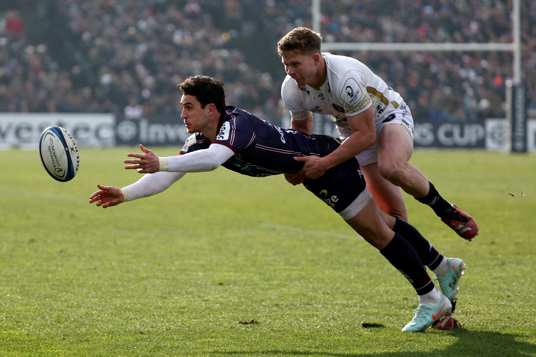 Bordeaux-Begles' Irish fly-half Joey Carbery (L) is tackled by Sharks' South African wing Ethan Hooker during the European Rugby Champions Cup match between Union Bordeaux-Begles (UBB) and the Sharks (RSA) at The Chaban-Delmas Stadium in Bordeaux, south-western France on January 19, 2025.