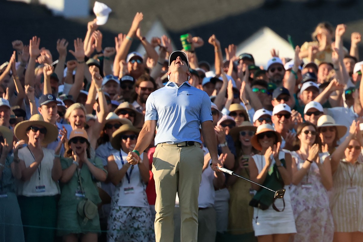 Rory McIlroy of Northern Ireland celebrates holing the winning putt on the 18th green during the final round