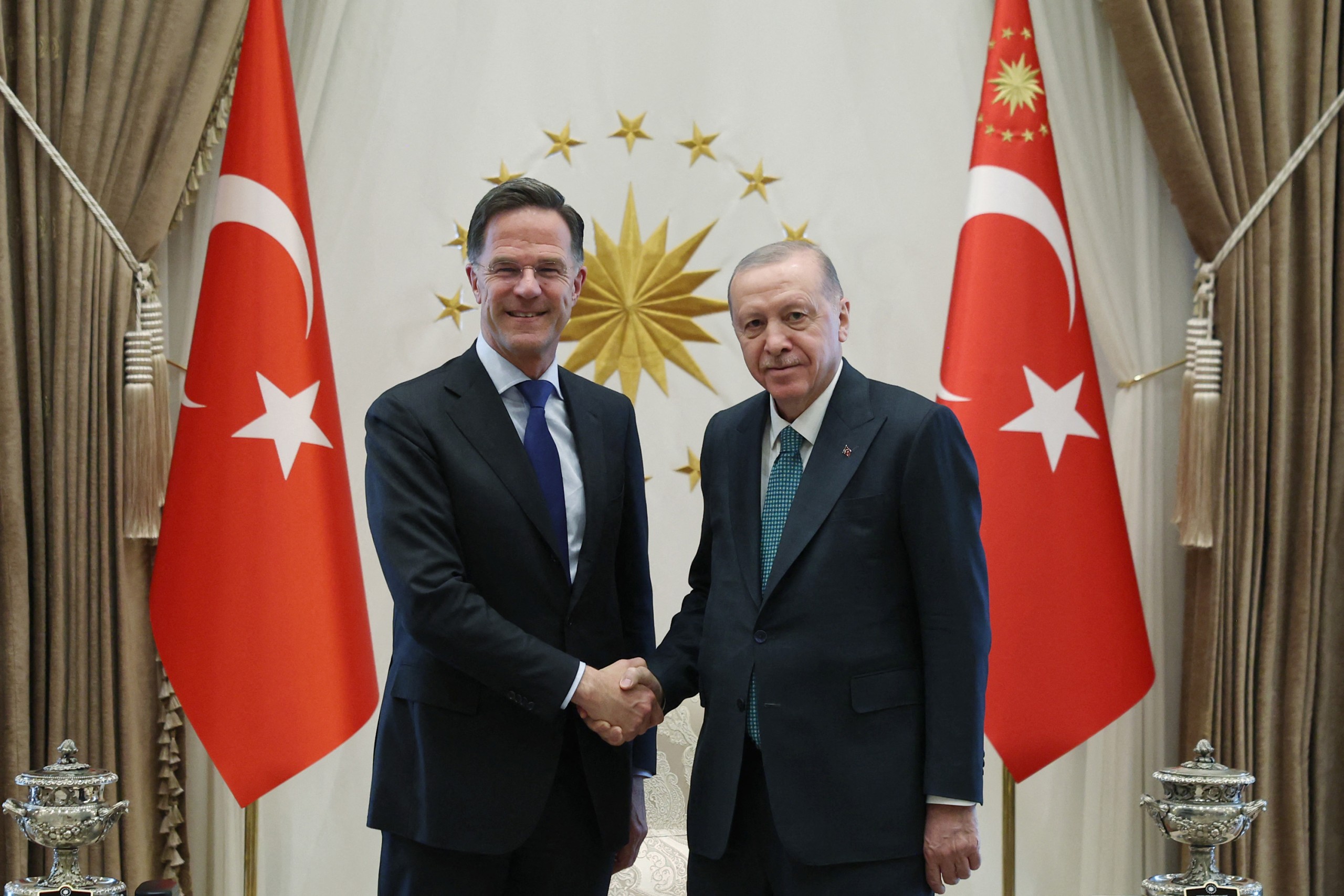 Turkey's President Recep Tayyip Erdogan (R) shaking hands with NATO Secretary General Mark Rutte at the Presidential Complex in Ankara.