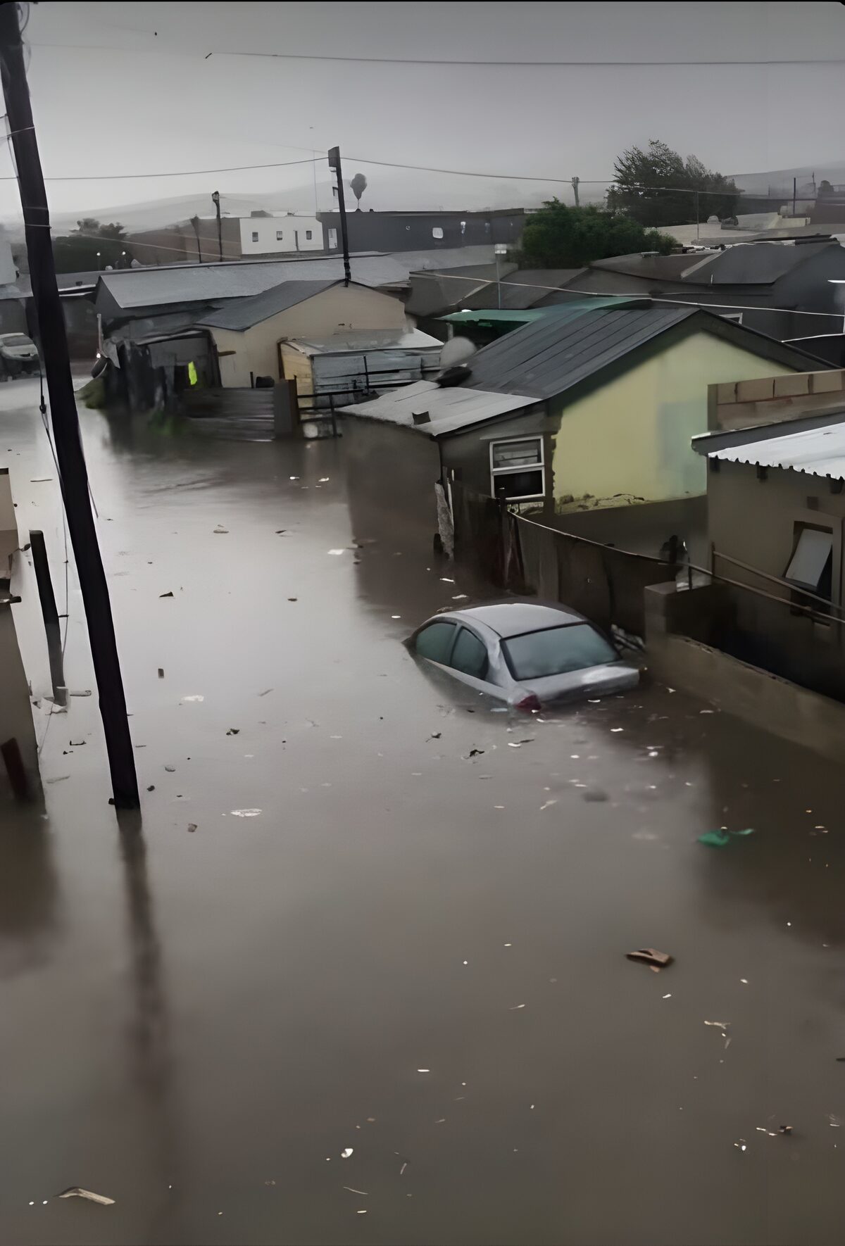 A silver sedan is seen nearly submerged as heavy flooding sweeps through Dunoon following days of persistent rain. Photo: Facebook