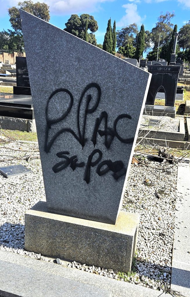 The back of a tombstone was spray-painted with foul language.