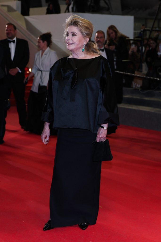 French actress Catherine Deneuve leaves after the screening of the film "Gentle Monster".