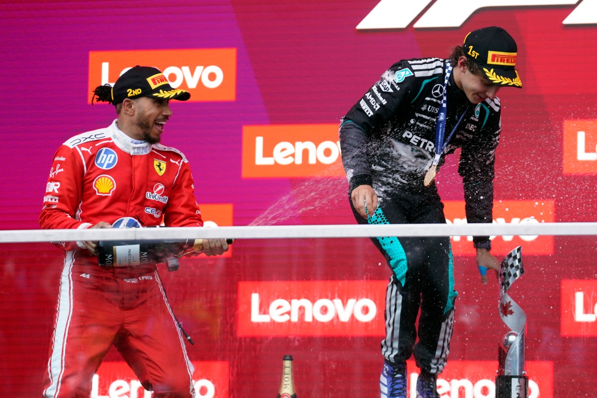Race winner Mercedes' Italian driver Kimi Antonelli is sprayed with champagne by second place Ferrari's British driver Lewis Hamilton.