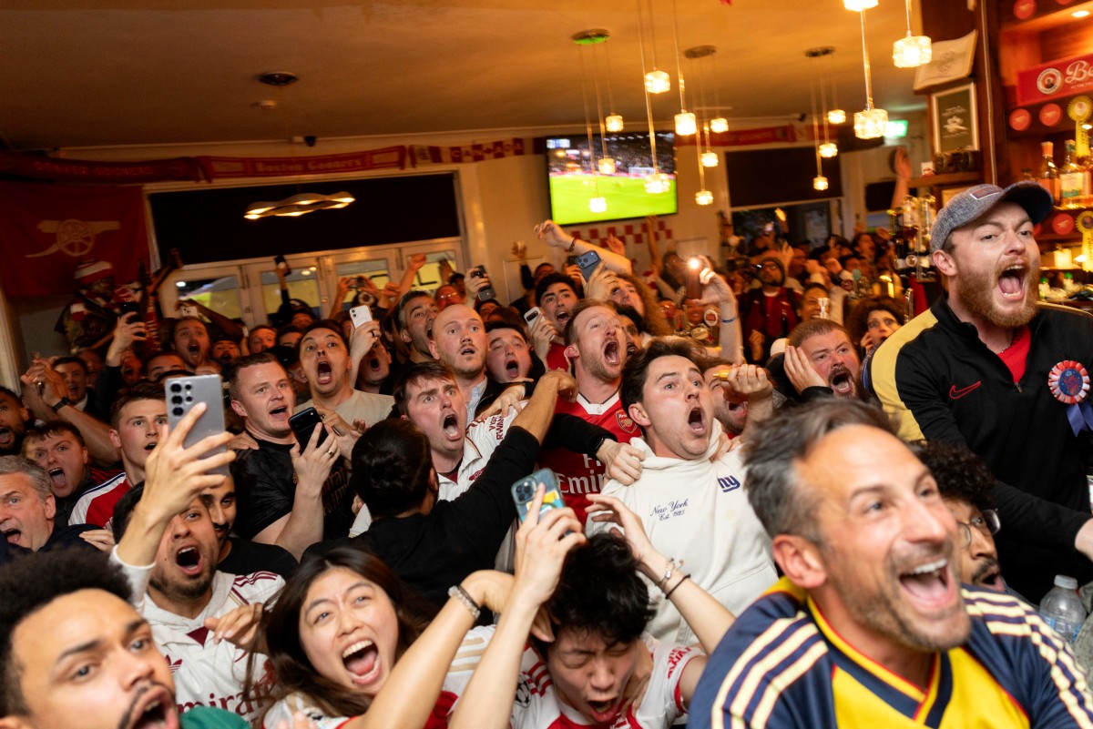 Arsenal fans watch as Bournemouth play Manchester City, from inside the Tollington Arms pub near the Emirates Stadium
