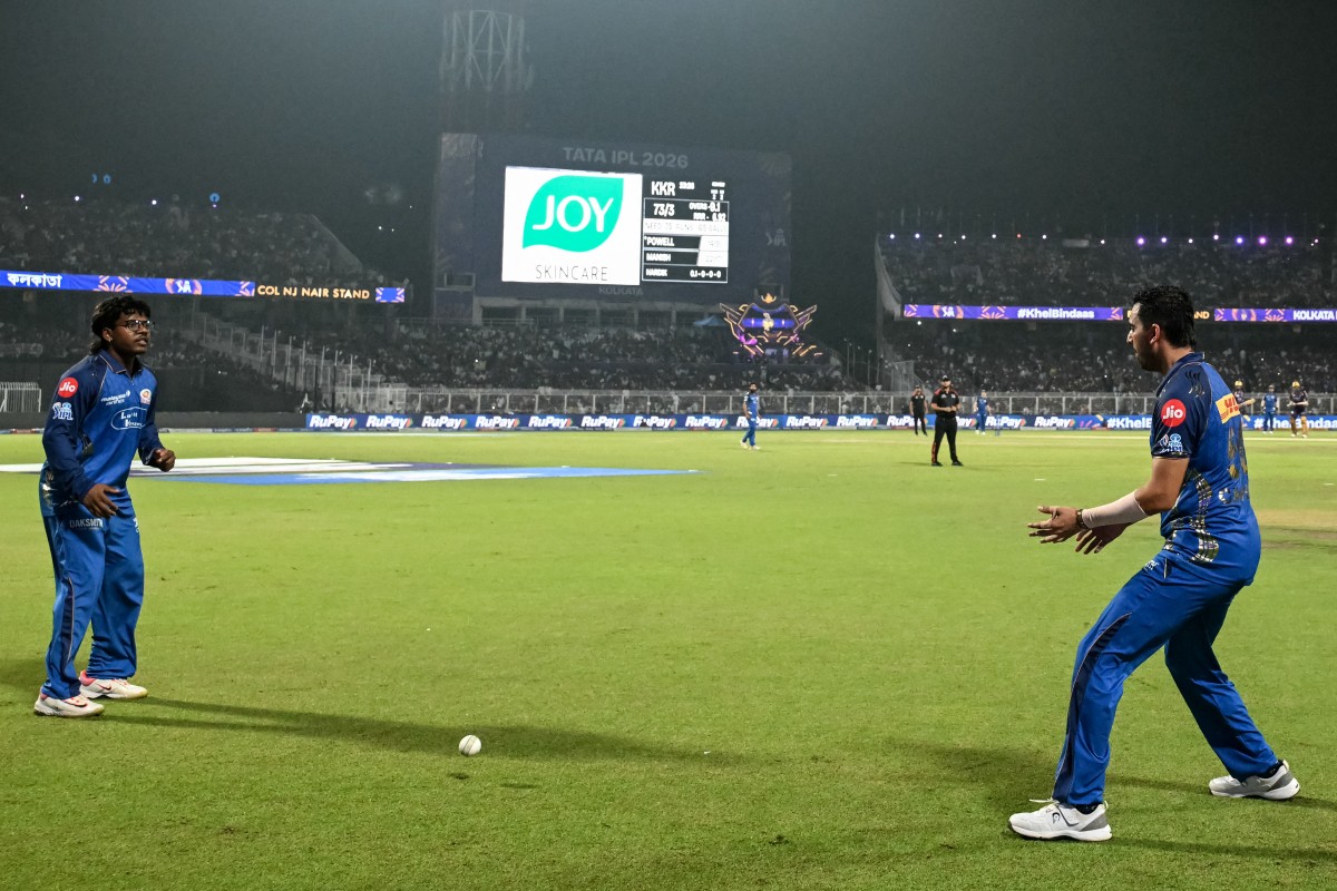 Mumbai Indians' Indian cricket player Robin Minz (L) and teammate Deepak Chahar (R) react after missing a catch