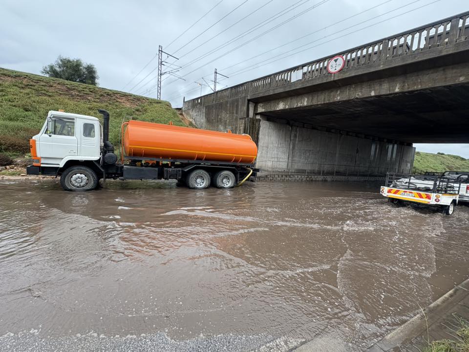 A water truck is actively pumping out excess water to improve drainage and restore safer driving conditions in Addo Road.