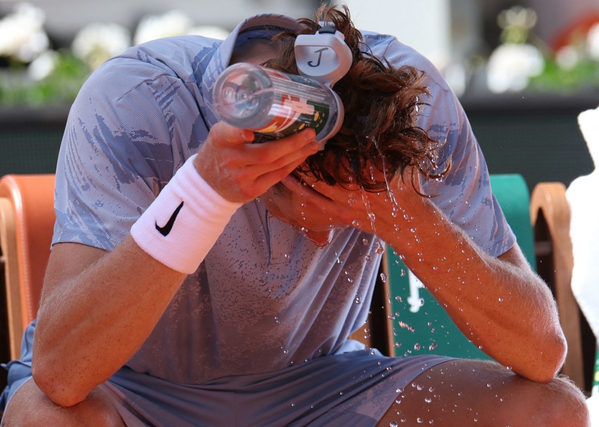 Jannik Sinner tries to cool down during a break of play in his men's singles match against Argentina's Juan Manuel Cerundolo