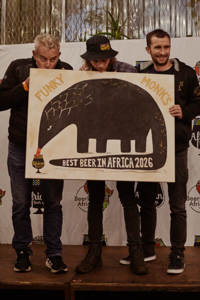 The Woodstock Brewery team celebrate with their custom painting created by Maggie Murray of Carvel