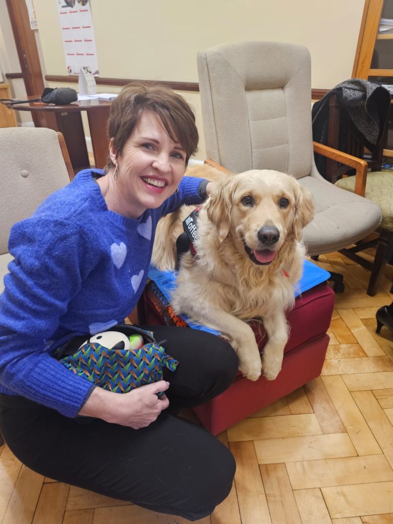 Child trauma specialist Edith Kriel and Toffee, the golden retriever therapy dog.