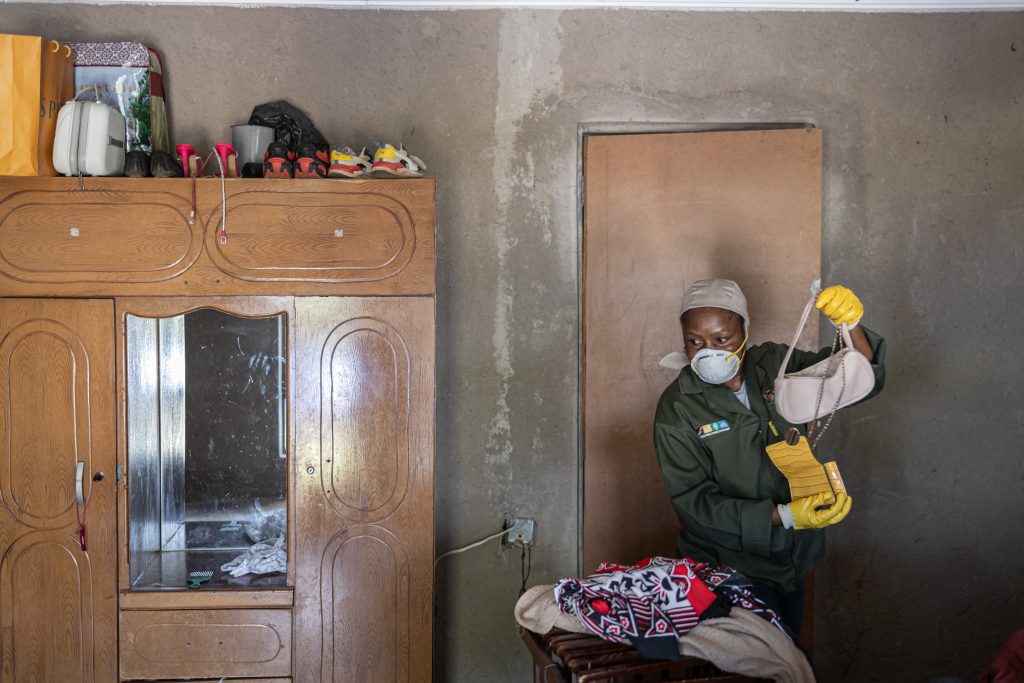 Health workers spray anti-mosquito insecticide inside a home in Calcutta village, Mpumalanga.