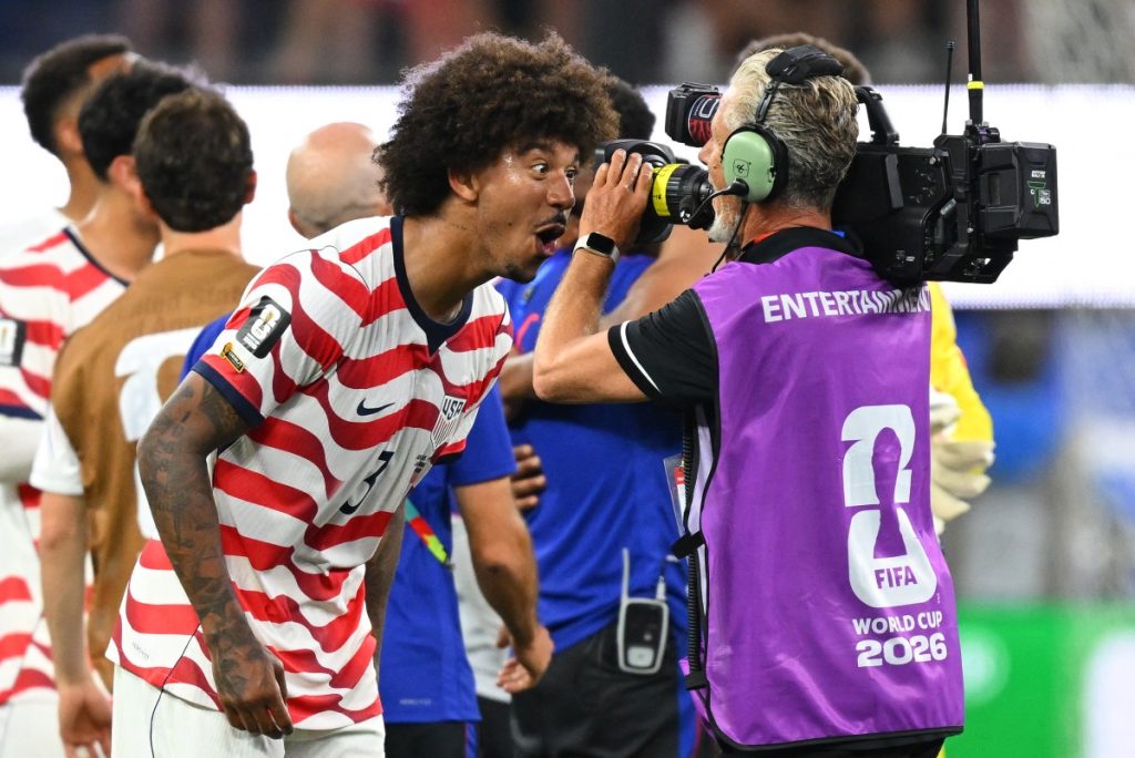 US defender Chris Richards celebrates in front of TV camera after winning the World Cup football match against Paraguay.