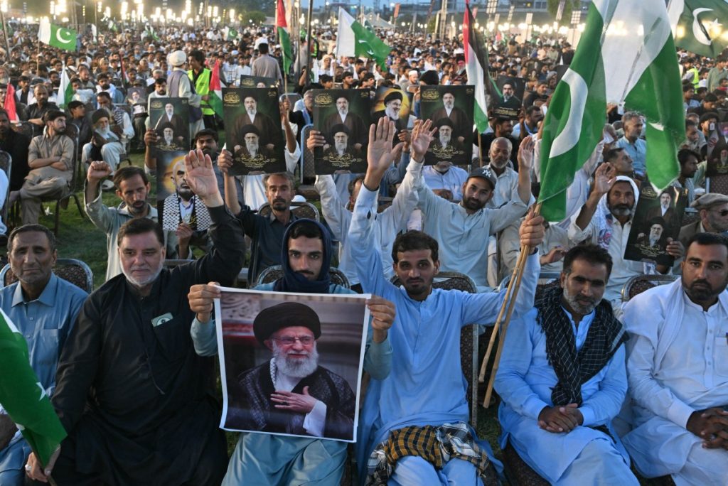 Activists with portraits of Iran's slain supreme leader Ayatollah Ali Khamenei,