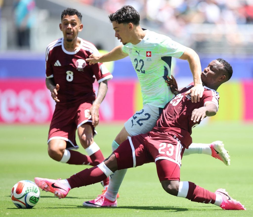 Fabian Rieder of Switzerland is challenged by Assim Madibo of Qatar.