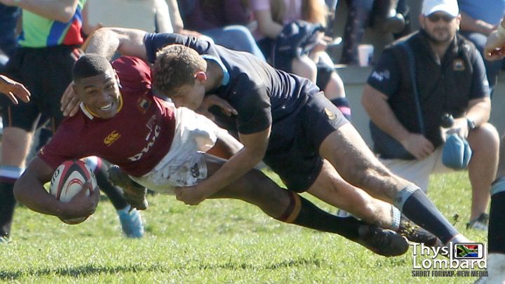 Damian Willemse is tackled by Jean Pienaar, son of Francois Pienaar. Willemse played for Paul Roos while Pienaar ran out for Bishops.