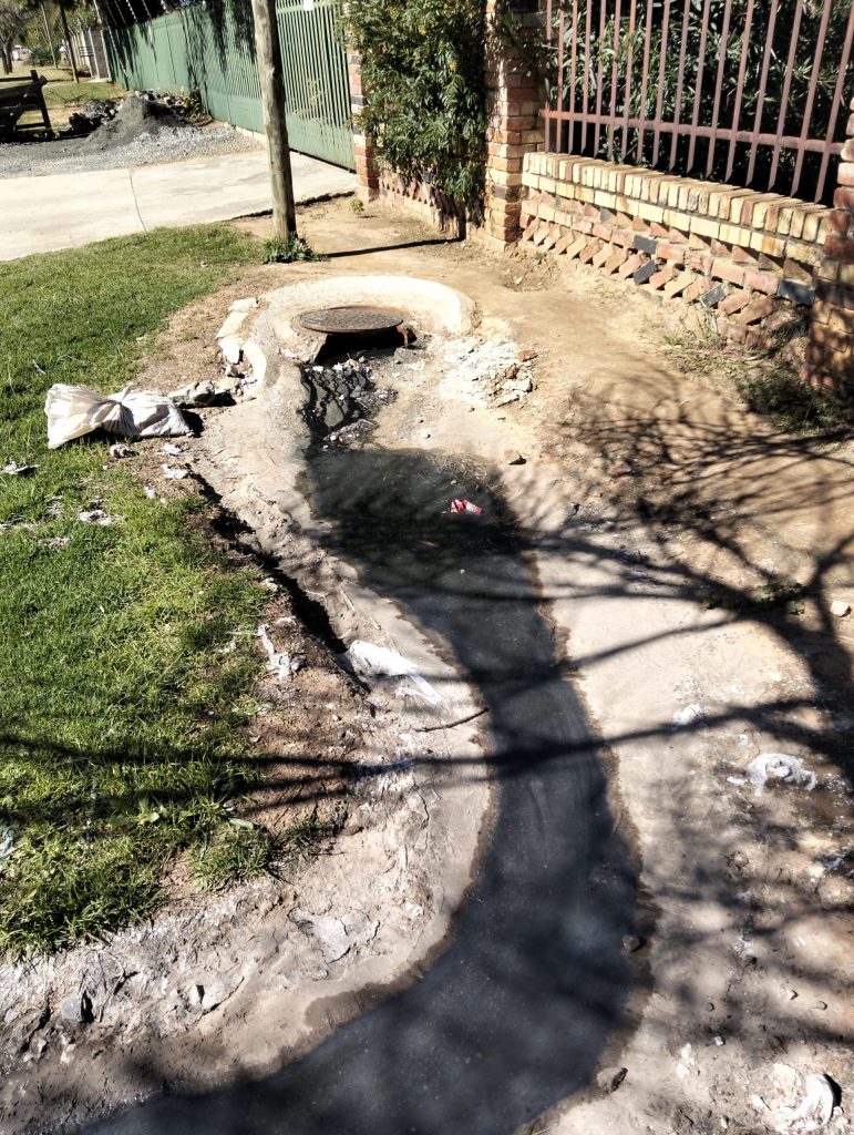 Raw sewage gushing out of a burst pipe adjacent to the St Helena Primary School in Unicor Street