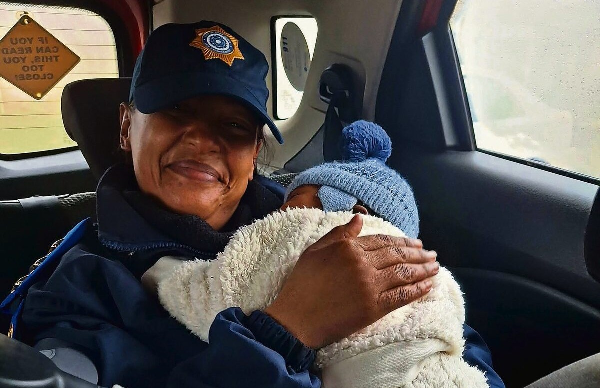 Senior Inspector Deirdré Thomas consoling the baby.