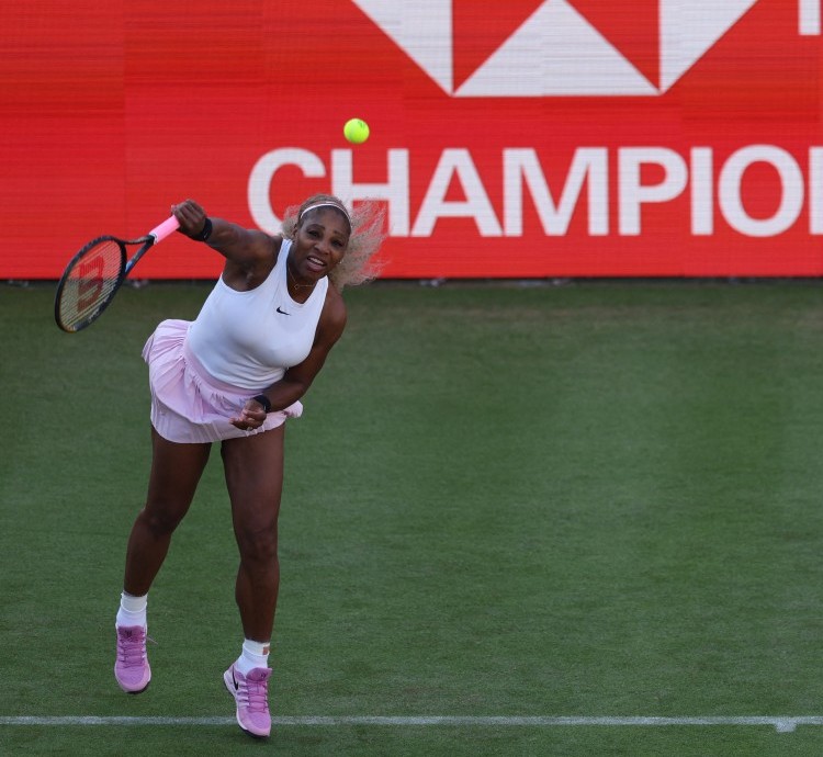 US player Serena Williams serves while playing with Canada's Victoria Mboko against US player Nicole Melichar-Martinez and New Zealand's Erin Routliffe during their round of 16, doubles match at the HSBC WTA tennis Championships at Queen's Club in west London