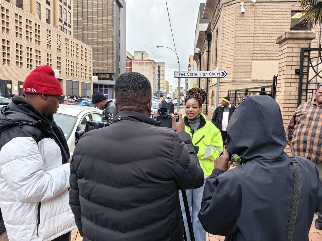 Ntombi Nhlapo, the Member of the Mayoral Committee (MMC) for Human Settlements in the Mangaung Metro, talking to reporters in front of the Free State High Court.