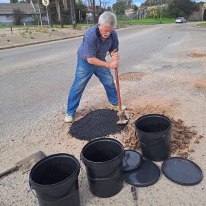 Resident takes pothole repairs into his own hands