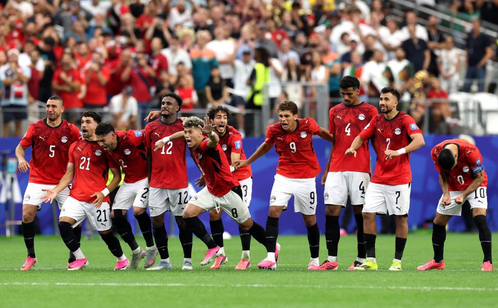 Egypt players celebrate their last 32 win over Australia.