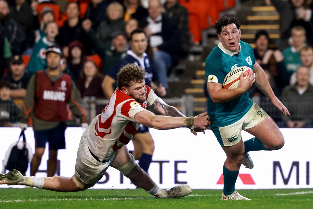 Ireland's Tom Stewart scores past Japan's Warner Dearns during the Nations Championship match in Newcastle.