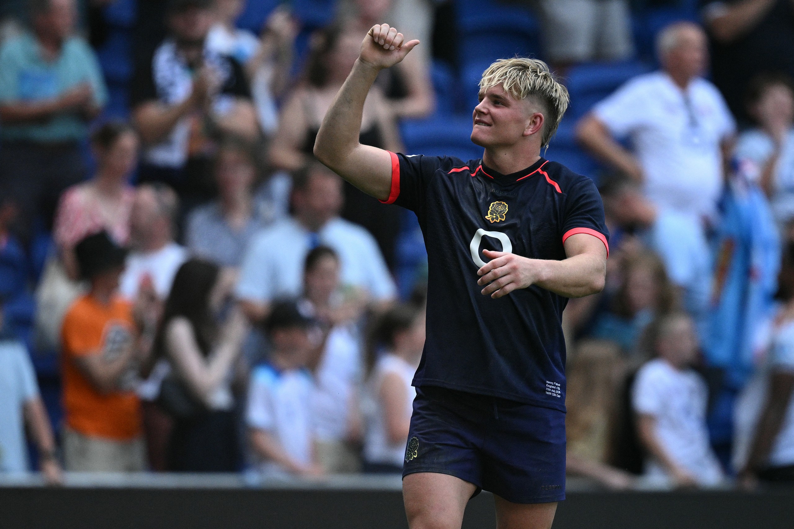 Henry Pollock celebrates after scoring one of his three tries.