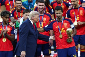 Trump lingers on stage to lap up World Cup spotlight