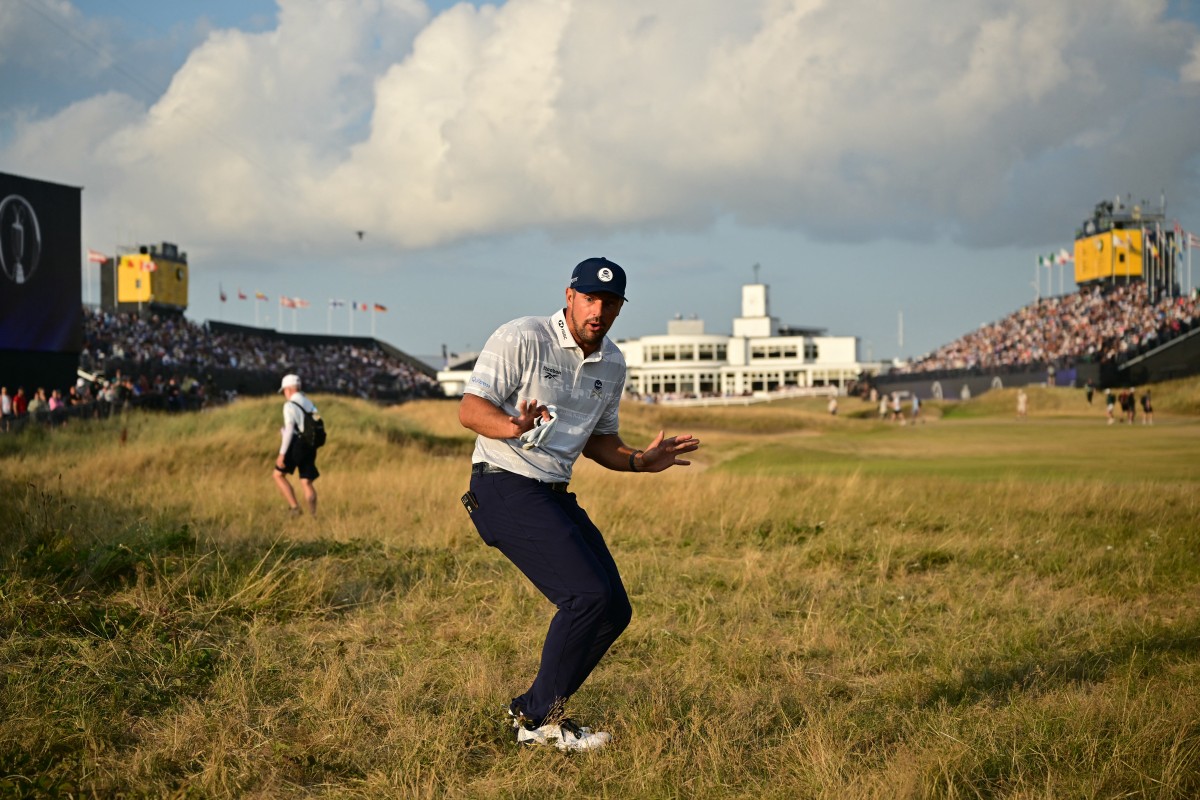 US golfer Bryson DeChambeau jokes with fans as he walks in the rough on the 18th hole at Royal Birkdale Golf Club.