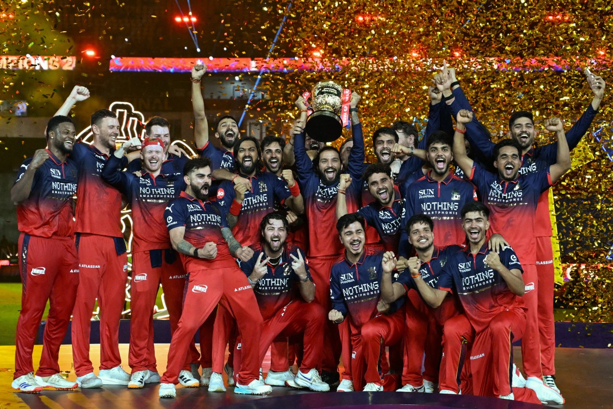 Royal Challengers Bengaluru cricket players celebrate with the trophy after winning the 2026 Indian Premier League