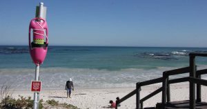 Two young surfers save a friend in distress with pink rescue buoy
