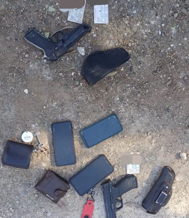 Handguns and other belongings recovered during the police operation.