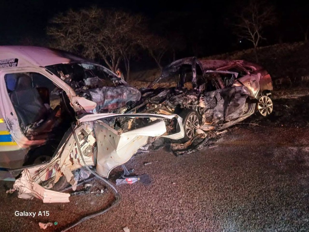 The burnt-out sedan and police minibus on the N1 freeway near Polokwane.
