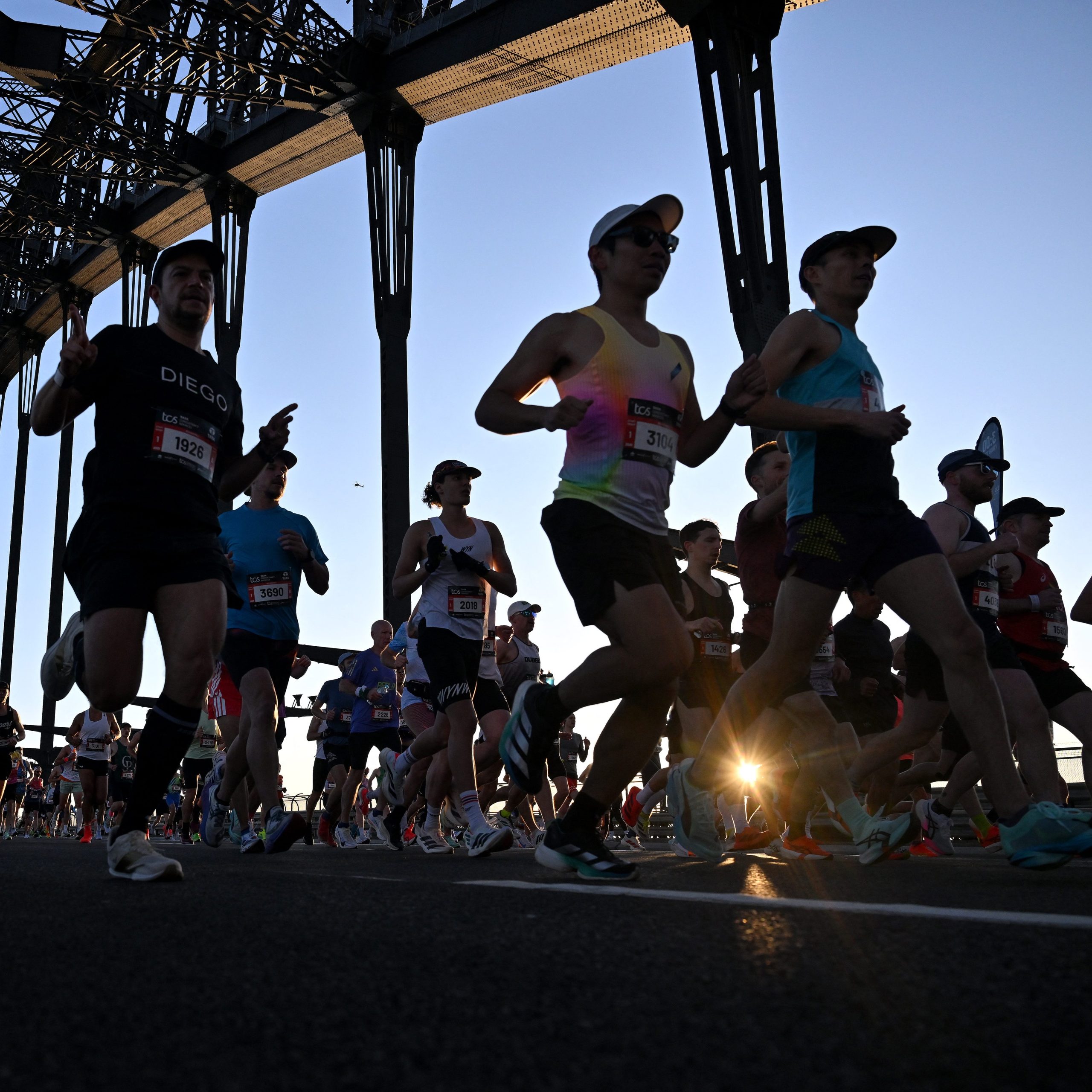 Athletes running across Sydney Harbour Bridge during the 2025 Sydney Marathon