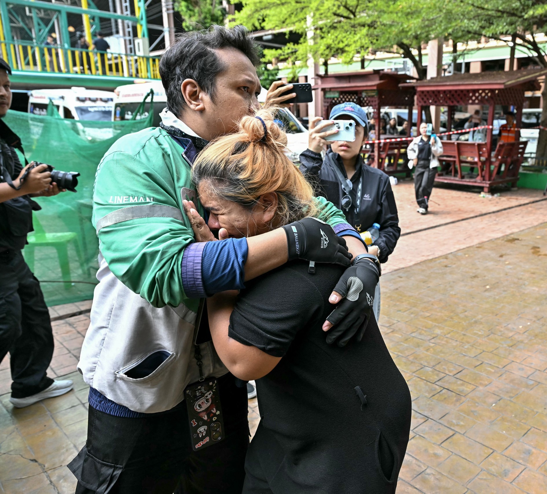 Family members of a school shooting victim mourn as bodies of the deceased are placed into ambulances at the school in Bang Kruai district, north of the Thai capital Bangkok. (Photo: Lillian Suwanrumpha, AFP)