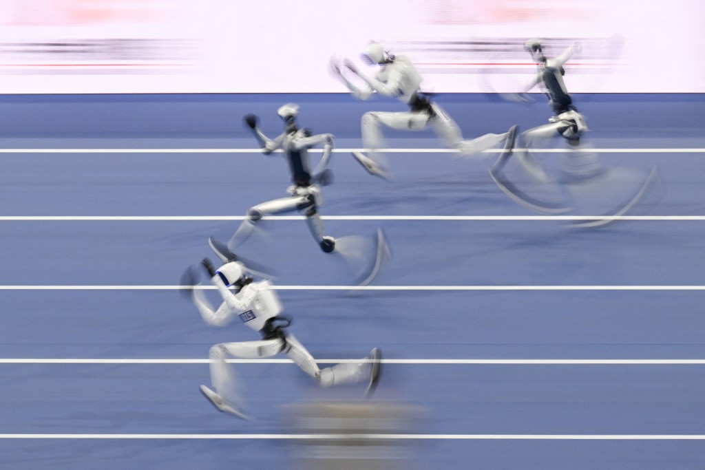 Humanoid robots compete in the 100-meter race. PHOTO: WANG Zhao / AFP