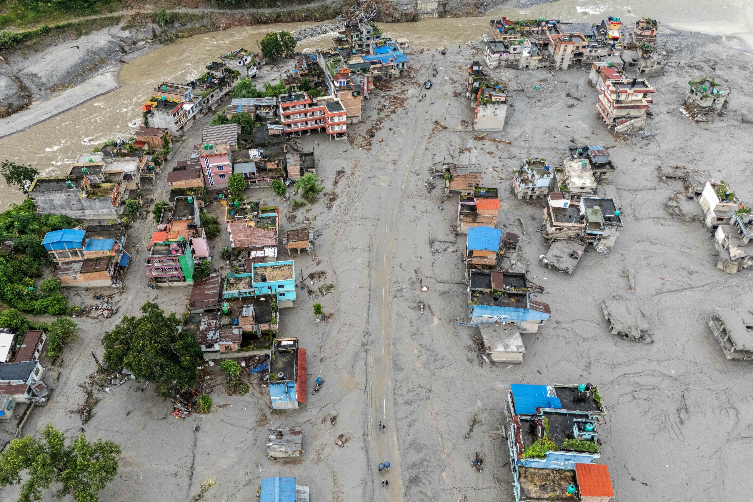 An aerial view shows houses covered in sludge in the aftermath of flash floods at Devighat in Nuwakot district. Photo: Manan Vatsyayana/AFP