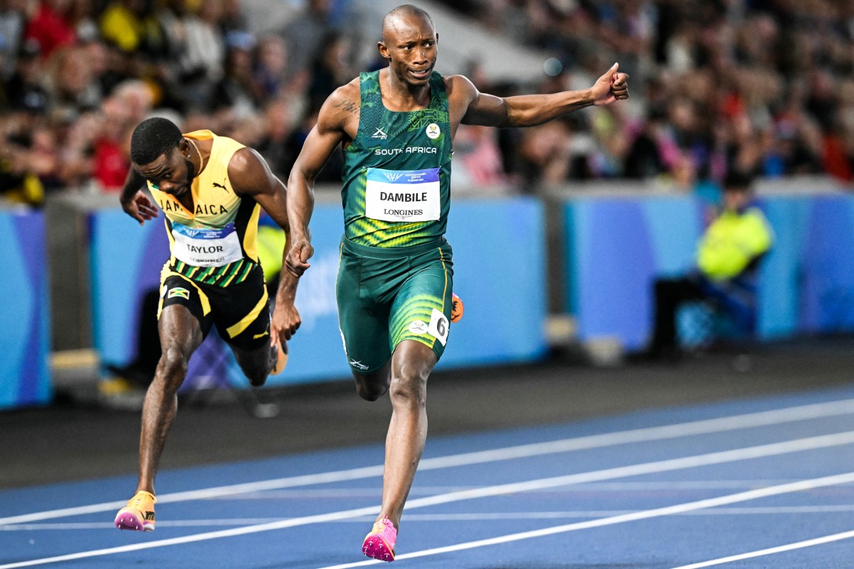 Sinesipho Dambile crosses the finish line past Jamaica's Christopher Taylor to win the men's 200m final