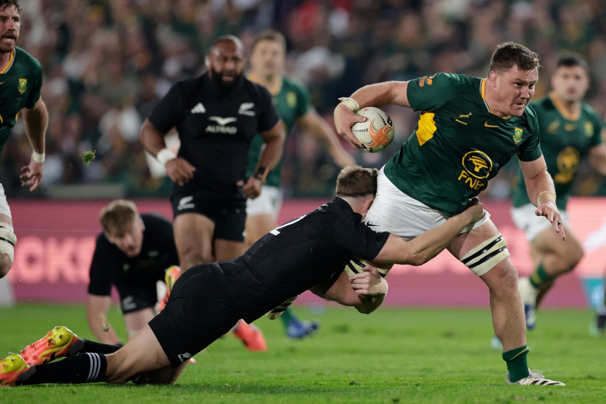 South Africa's number eight Jasper Wiese is tackled by New Zealand's centre Jordie Barrett during the Rugby's Greatest Rivalry match