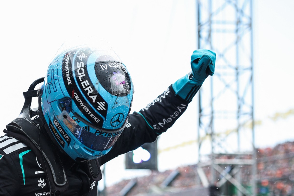 Mercedes' British driver George Russell gestures as he celebrates after winning the sprint race ahead of the Formula One Dutch Grand Prix