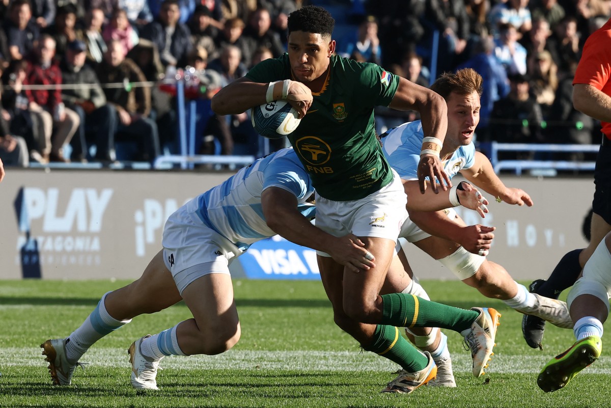 South Africa's fly half Sacha Feinberg-Mngomezulu is tackled by Argentina's centre Faustino Sanchez Valarolo