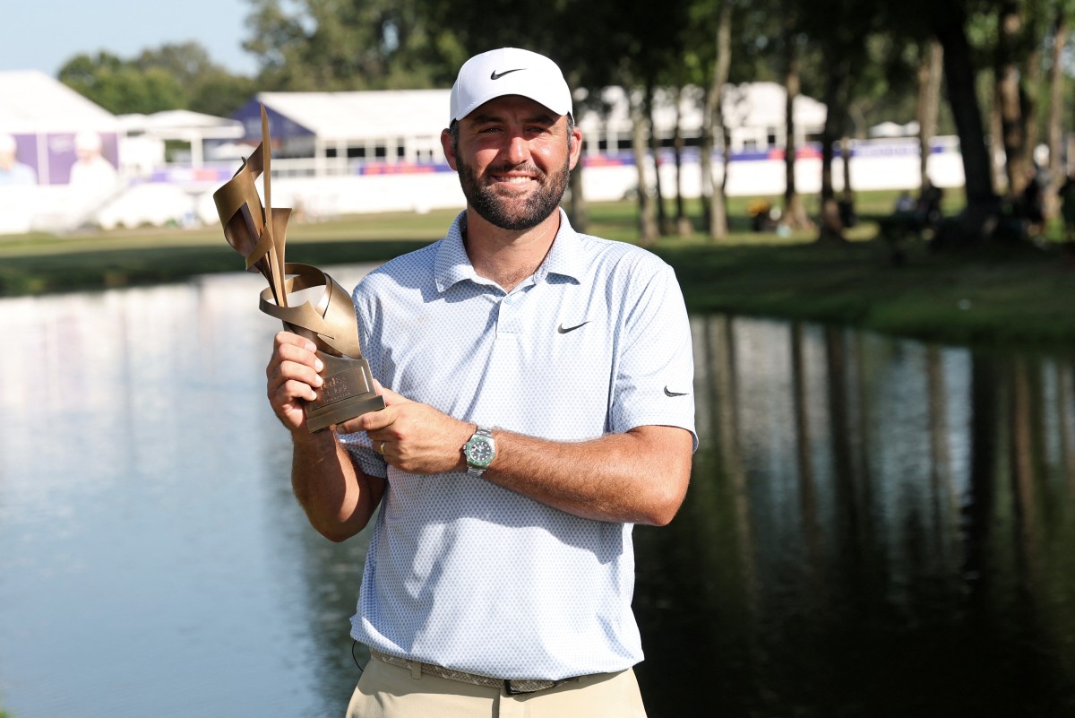Scottie Scheffler celebrates with the trophy after winning during the final round of the FedEx St. Jude Championship.