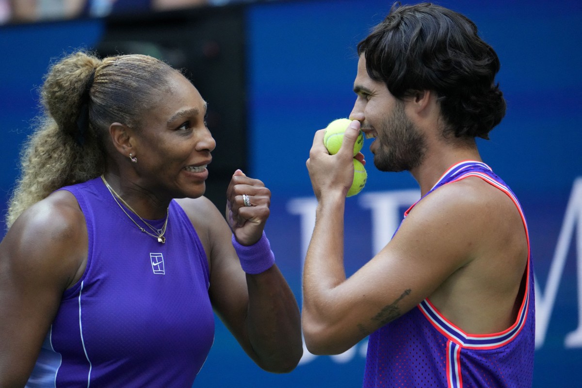 USA's Serena Williams and Spain's Carlos Alcaraz confer during their mixed doubles tennis match against Switzerland's Belinda Bencic and Italy's Flavio Cobolli