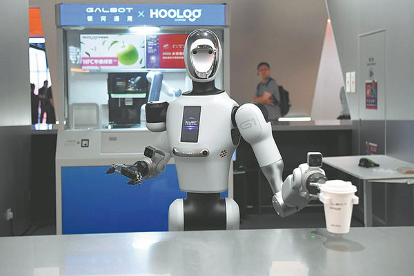 A robot serves coffee in the exhibition hall of the National Pilot Base for Embodied AI Applications in Hangzhou, Zhejiang province, in May. FAN YUQING/XINHUA