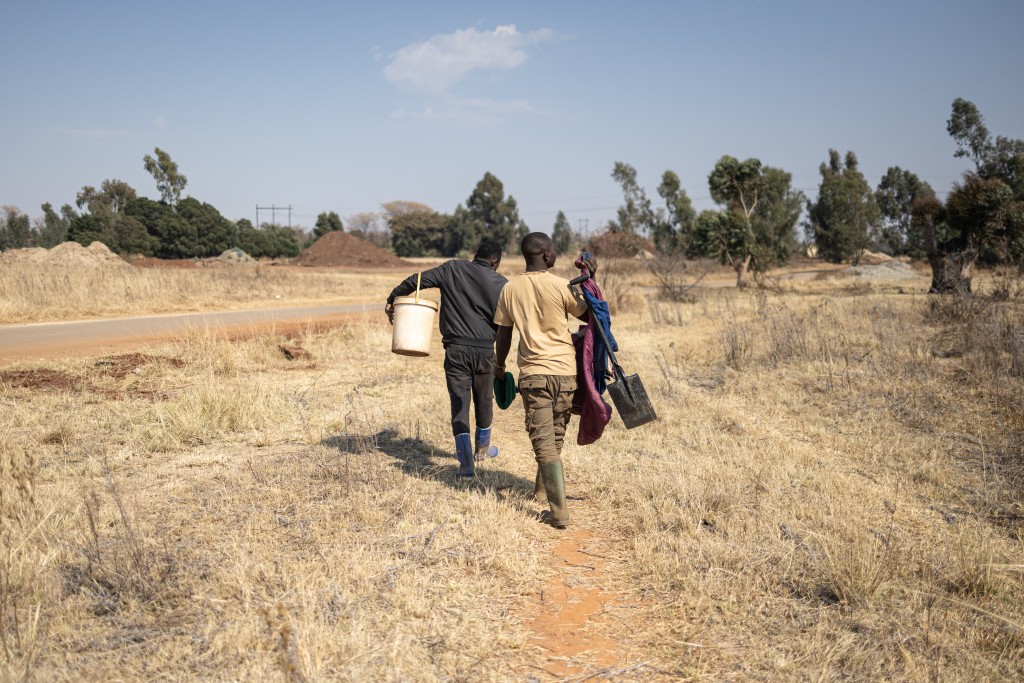 Zama zamas walk on in a field in Carletonville.  PHOTO: Emmanuel Croset